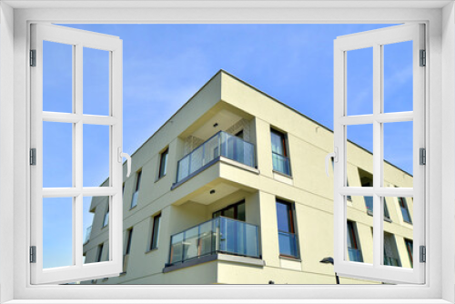 Fototapeta Naklejka Na Ścianę Okno 3D - Apartment residential house and home facade architecture and outdoor facilities. Blue sky on the background. Sunlight in sunrise.