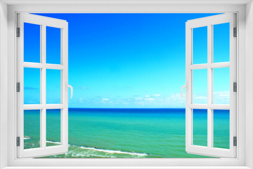 Fototapeta Naklejka Na Ścianę Okno 3D - Beautiful view of the Adriatic Coast in Ortona with serene azure sky and colorful sea ranging from cyan to deep blue with pure white foam fuming behind rocks on a sunny summer day
