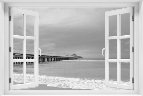 Fototapeta Naklejka Na Ścianę Okno 3D - Black and white image of Side view of pier at the beach at sunset time.Thailand.