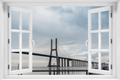 Fototapeta Naklejka Na Ścianę Okno 3D - Beautiful long Vasa da Gama bridge with a pier. Lisbon, Portugal