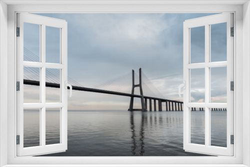Fototapeta Naklejka Na Ścianę Okno 3D - Amazing beautiful long Vasco da Gama Bridge on a cloudy day in Lisbon, Portugal