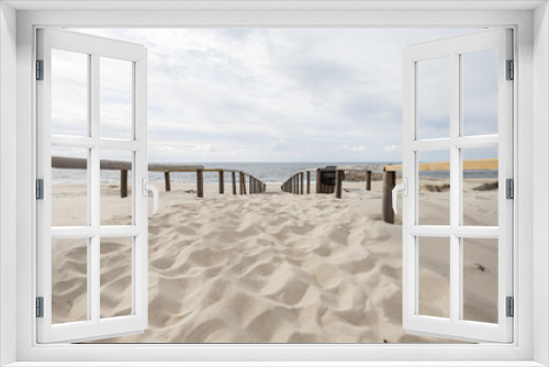 Fototapeta Naklejka Na Ścianę Okno 3D - Beautiful beach with sand and wooden walkway by the ocean