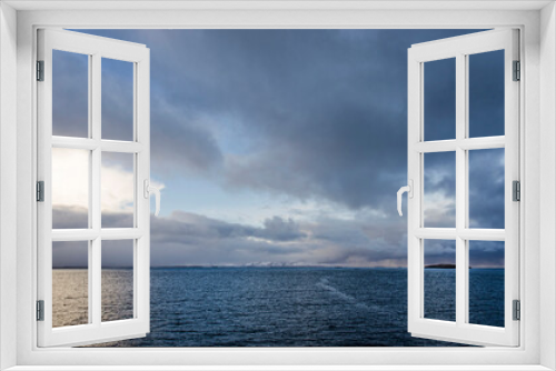 Fototapeta Naklejka Na Ścianę Okno 3D - View from the deck of a ferryboat across Breiðafjörður in Iceland under a sky with spectacular clouds