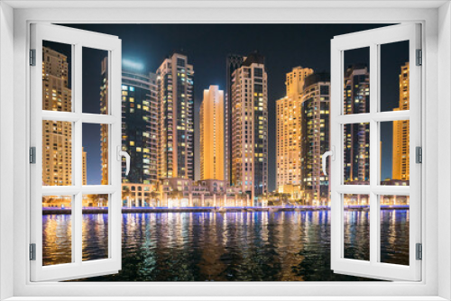 Fototapeta Naklejka Na Ścianę Okno 3D - Night view of high-rise buildings of residential district in Dubai Marina. Dubai Marina Towers. Dubai Marina Skyline Background. Holidays In United Arab Emirates. Vacation In UAE. Night view of high