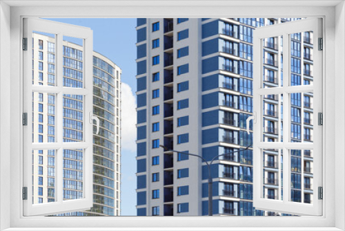Fototapeta Naklejka Na Ścianę Okno 3D - Contemporary high-rise apartment buildings, frame-block construction, ventilated glass facade