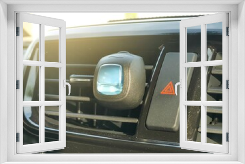 Fototapeta Naklejka Na Ścianę Okno 3D - Perfume mount on an aircond vent of a car with emergency button.