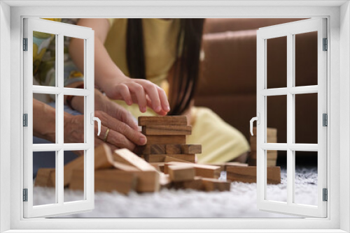 Fototapeta Naklejka Na Ścianę Okno 3D - Cropped shot grandmother playing wooden blocks with her little grandchild in living room ,spending happy time on weekend together.