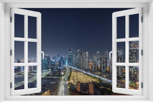 Fototapeta Naklejka Na Ścianę Okno 3D - Bay Avenue with modern towers residential development in Business Bay aerial panoramic night timelapse, Dubai