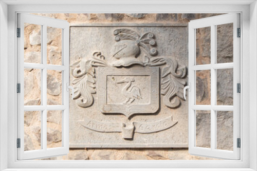 Fototapeta Naklejka Na Ścianę Okno 3D - medieval coat of arms shield sculpture in a stone wall with the legend or inscription 