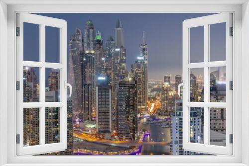 Fototapeta Naklejka Na Ścianę Okno 3D - View of various skyscrapers in tallest recidential block in Dubai Marina aerial day to night timelapse