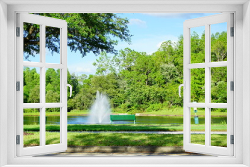 Fototapeta Naklejka Na Ścianę Okno 3D - A Florida community pond and water front bench 
