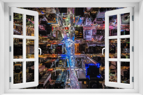 Fototapeta Naklejka Na Ścianę Okno 3D - Night life in modern metropolis. Birds eye shot of high rise buildings and streets. Large display on Times Square glowing colour light to surround. Manhattan, New York City, USA