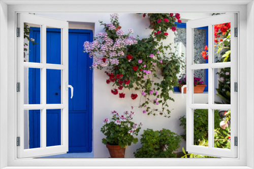 Fototapeta Naklejka Na Ścianę Okno 3D - Blue door and windows in a patio with flowers in spring, Cordoba, Spain