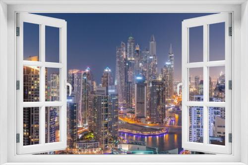Fototapeta Naklejka Na Ścianę Okno 3D - View of various skyscrapers in tallest recidential block in Dubai Marina aerial day to night timelapse