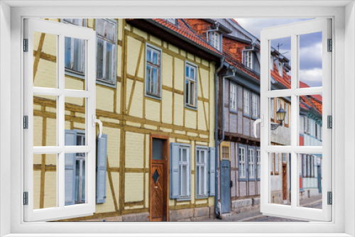 Fototapeta Naklejka Na Ścianę Okno 3D - Street with colorful half timbered houses in Quedlinburg, Germany