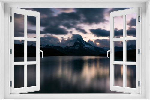 Beautiful sunset colors and cloudscape in the Swiss Alps in summer, with Matterhorn reflection in a lake