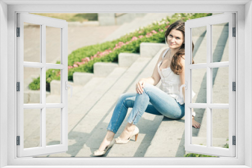 Portrait of a beautiful european woman sitting om steps