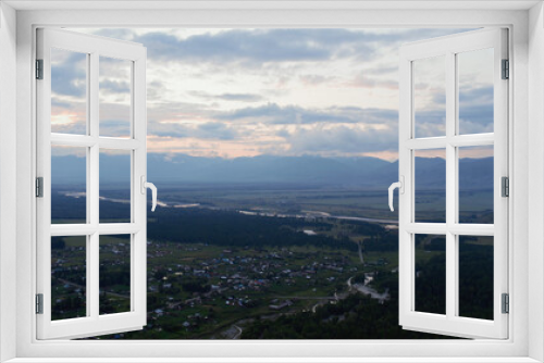 Fototapeta Naklejka Na Ścianę Okno 3D - Aerial view of valley and country houses under blue sky in sunset time