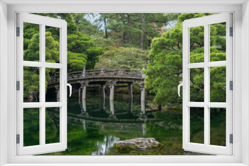 Fototapeta Naklejka Na Ścianę Okno 3D - Historic stone bridge at Gonaitei garden on beautiful autumn day in Kyoto Imperial palace in Kyoto, Japan. Oike-niwa - serene japanese zen garden and pond
