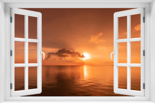 Fototapeta Naklejka Na Ścianę Okno 3D - Stunning sun rising on horizon reflecting on a calm sea, clouds and sea in pink yellow colors. New day concept.