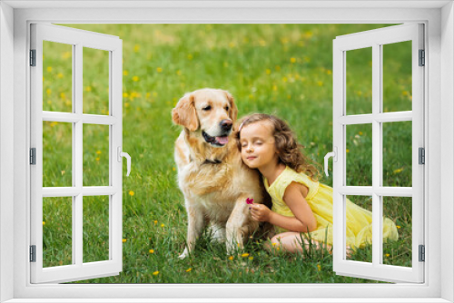 Fototapeta Naklejka Na Ścianę Okno 3D - the relationship of a child with a golden retriever dog on the grass in the park