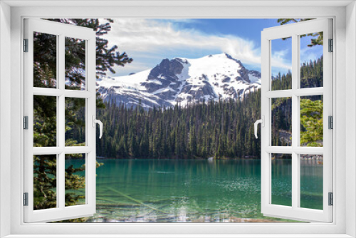 Fototapeta Naklejka Na Ścianę Okno 3D - Green lake with reflection of forest and snowy mountains on the background in Joffre Lakes, BC, Canada