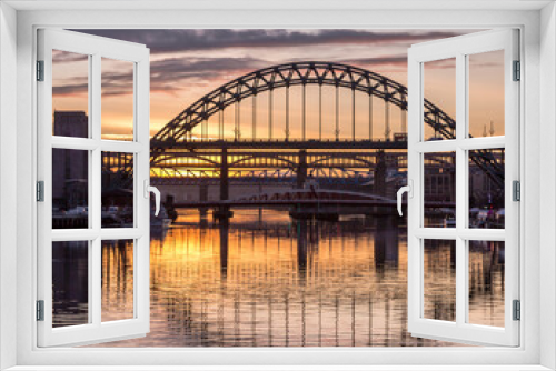 Fototapeta Naklejka Na Ścianę Okno 3D - The Tyne Bridge in Newcastle at sunset, reflecting in the almost still River Tyne beneath