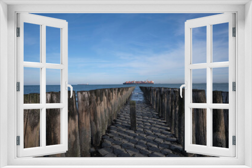 Fototapeta Naklejka Na Ścianę Okno 3D - Pier with wooden posts at the North Sea coast in the province of Zeeland, The Netherlands