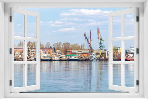 Fototapeta Naklejka Na Ścianę Okno 3D - River port with moored old ships and cargo cranes
