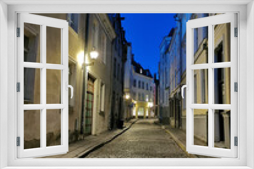 Fototapeta Naklejka Na Ścianę Okno 3D - One of the narrow, cobbled streets of Old Tallinn against the blue sky. Spring evening.