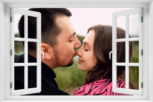 Young couple in love outdoor.Stunning sensual outdoor portrait of young stylish fashion couple posing in summer