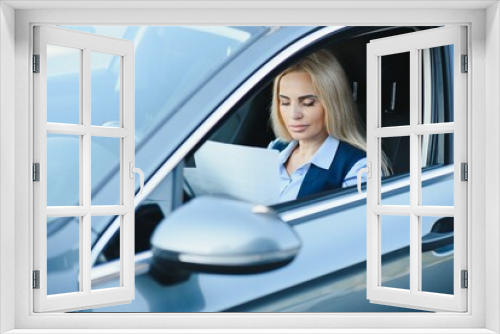 Fashion business woman with financial papers by her car