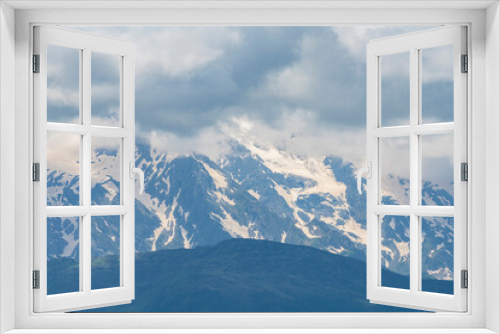 Fototapeta Naklejka Na Ścianę Okno 3D - Beautiful snow covered mountains with in the fog and dramatic clouds.