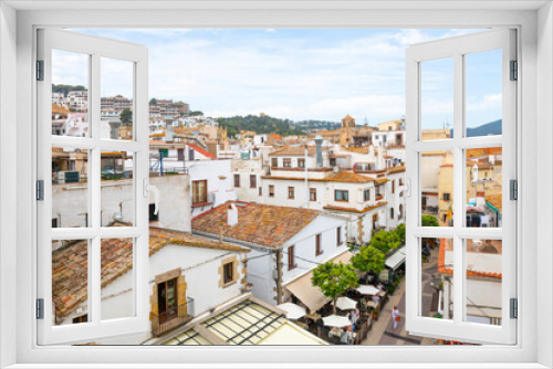 Fototapeta Naklejka Na Ścianę Okno 3D - The whitewashed Spanish town of Tossa de Mar, Spain, on the Costa Brava coastline, with streets of shops and cafes in it's touristic old town.