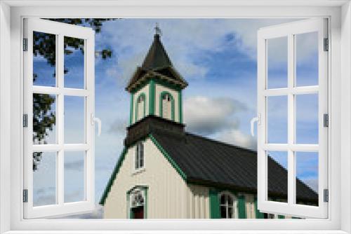 Fototapeta Naklejka Na Ścianę Okno 3D - THINGVALLAKIRKJA, first church built in Iceland, beautiful wooden chapel house in a forest with blue sky