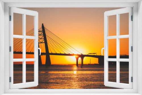 Fototapeta Naklejka Na Ścianę Okno 3D - Cable-stayed bridge over the river - silhouette at sunset