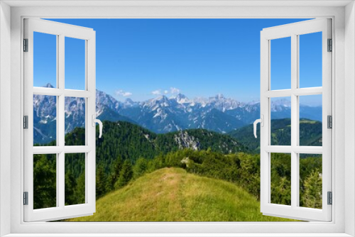 Fototapeta Naklejka Na Ścianę Okno 3D - View of mountain peaks in Julian alps and Triglav national park, Slovenia and a ridge in Karavanke mountains bellow Trupijevo Poldne