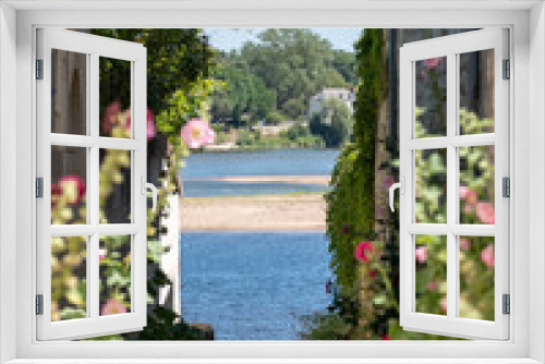 Fototapeta Naklejka Na Ścianę Okno 3D - Old stone houses and hollyhocks in the picturesque village of Candes Saint Martin, at the confluence of the Loire and Vienne rivers. The village is considered one of the most beautiful in France.