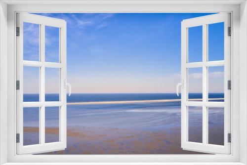 Fototapeta Naklejka Na Ścianę Okno 3D - Beautiful landscape of an empty beach against a blue sky background on a summer morning. A peaceful and quiet view of the ocean and the sea shore with copy space on a spring day