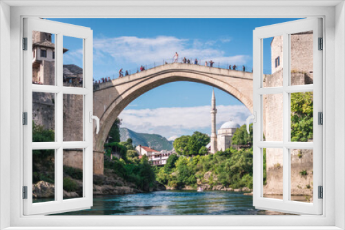 MOSTAR, BOSNIA AND HERZEGOVINA - September 21, 2021: Man is preparing to jump from Stari most, Old Bridge, in Mostar. Bosnia and Herzegovina