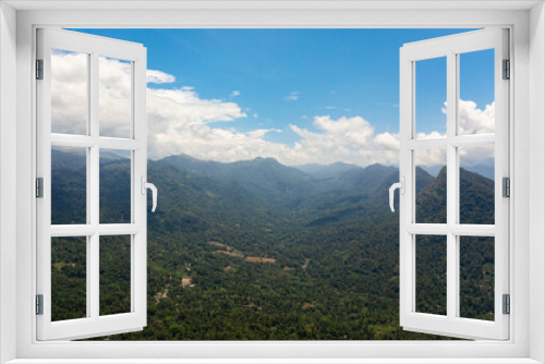 Mountains covered rainforest, trees and blue sky with clouds. Sri Lanka.