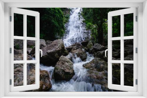 Fototapeta Naklejka Na Ścianę Okno 3D - Stream waterfall on rocks in the forest. Waterfall stream on rocks. Beautiful waterfall stream. Waterfall stream in forest Thailand