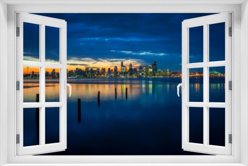 Fototapeta Naklejka Na Ścianę Okno 3D - Seattle Skyline During the Morning Blue Hour Seen From West Seattle.  Dynamic view of the Seattle cityscape just before dawn with Elliott Bay in the foreground and the waterfront in the distance. 