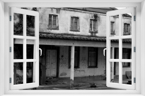 Fototapeta Naklejka Na Ścianę Okno 3D - Photograph of an abandoned house in black and white 