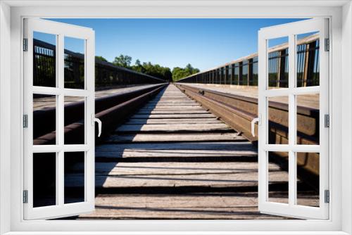 Fototapeta Naklejka Na Ścianę Okno 3D - Railroad tracks close to far symmetrical, perspective view with clear blue sky at Kinzua Bridge, Pennsylvania.