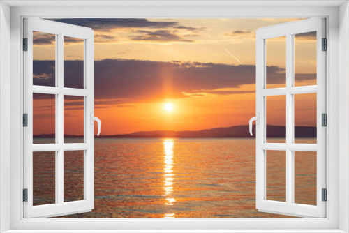 Fototapeta Naklejka Na Ścianę Okno 3D - Sunset over Aegean Sea. Greece. Golden reflection on rippled ocean water. Dark land and colorful sky