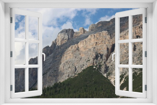 Fototapeta Naklejka Na Ścianę Okno 3D - Coravara, Italy-July 16, 2022: The italian Dolomites behind the small village of Corvara in summer days with beaitiful blue sky in the background. Green nature in the middle of the rocks.