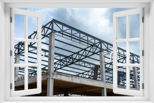 Fototapeta Naklejka Na Ścianę Okno 3D - Factory building structure with cement base and steel frame for metal sheet roofing.