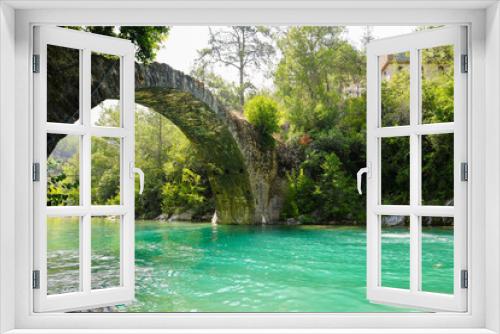 Fototapeta Naklejka Na Ścianę Okno 3D - Ancient roman bridge on Dim river in Turkey. Clear turquoise water and green nature.
