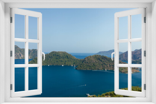 Fototapeta Naklejka Na Ścianę Okno 3D - Marmaris, Turkey – Beautiful view of the islands and the crystal clear water of the bay at sunny day with its misty green mountains at background and the blue bay.